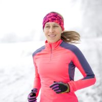 Woman out for a run in the winter snow to keep fit