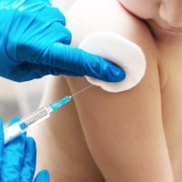 Young boy being vaccinated against the flu