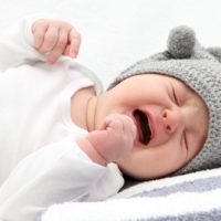 Baby crying and upset due to middle ear infection