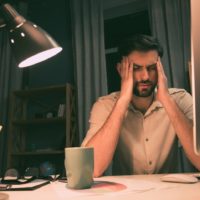 Businessman suffering from a bad headache and migraine after work