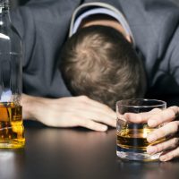 Drunk businessman holding a glass of whiskey