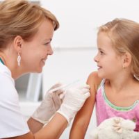 Brave girl under 5 years receiving flu vaccination