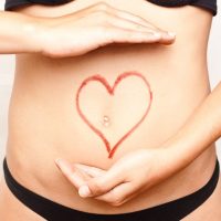 Woman holding hands around her healthy looking stomach