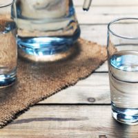 Glasses of water on a wooden table