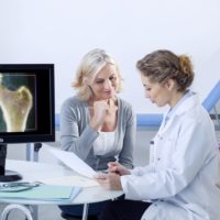 Rheumatology consultation with senior lady explaining new treatment options