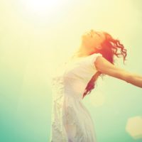 Woman in the sunlight happy because the flu vaccine is free