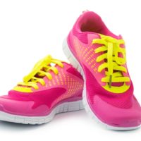 Pair of pink sport shoes on white background