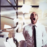 Businessman stressed and overworked yelling in office