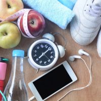 Healthy fitness and fruit concept with Exercise Equipment and fruit lose weight on wooden background