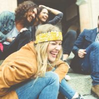 Group of four friends laughing out loud at medical jokes from Your Health website