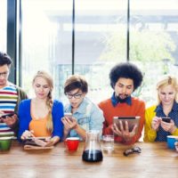 Multiethnic group of people social networking at cafe