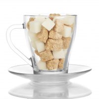 Lots of sugar cubes in glass mug