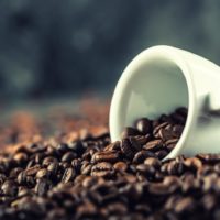 Coffee cup full of high caffeine strength coffee beans