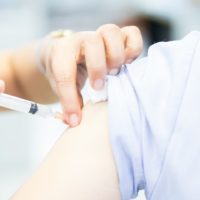 Flu vaccination being administered into the upper arm