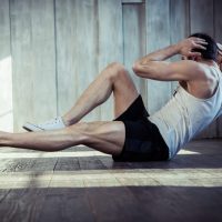 Young fit man undertaking a high intentisty interval training routine in a gym