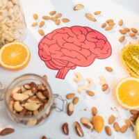 A drawing of a brain with health foods surrounding it
