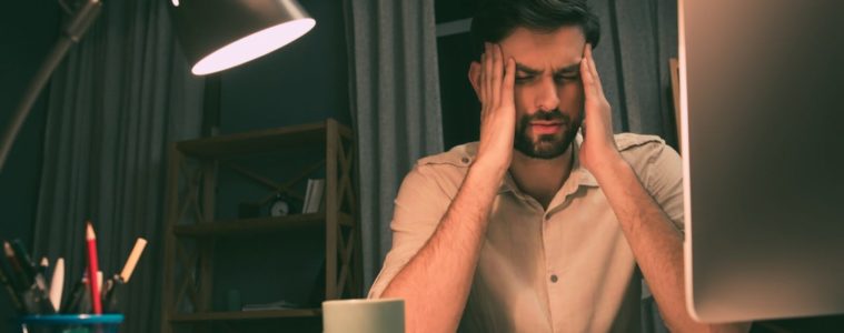 Businessman suffering from a bad headache and migraine after work