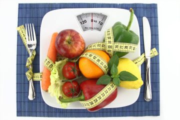 Fruits and vegetables with measuring tape on a plate as weight scale