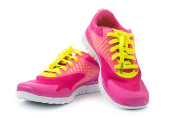 Pair of pink sport shoes on white background