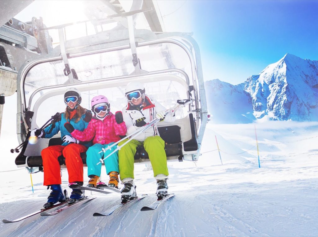 Healthy skiers on ski lift enjoying themselves