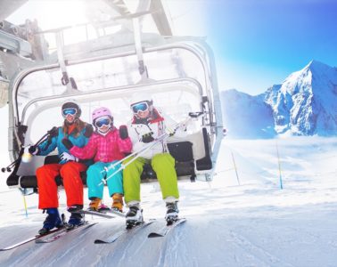 Healthy skiers on ski lift enjoying themselves