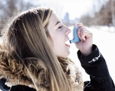 An Attractive young woman with asthma enjoying the winter outdoors