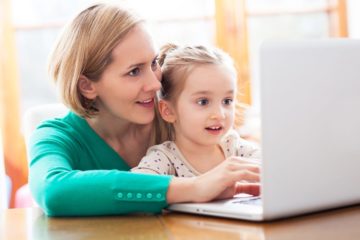 Mother and daughter using a laptop to surf the internet together