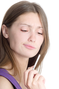 Woman holding cigarette thinking about lighting up