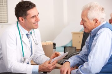 A general practitioner talking to senior man in his practice surgery