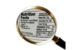 Magnifying glass over nutrition facts and carbohydrate values