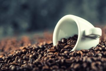 Coffee cup full of high caffeine strength coffee beans