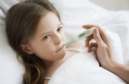 Young Sick Girl with Thermometer in Mouth