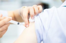 Flu vaccination being administered into the upper arm