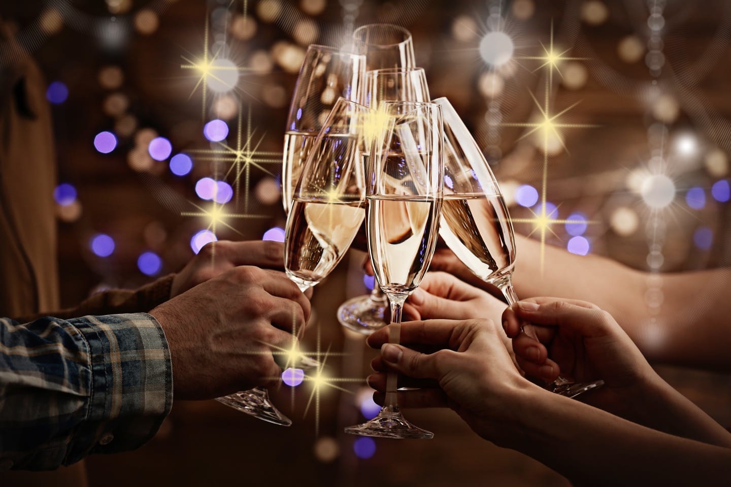 Clinking Glasses Of Champagne In Hands On Bright Lights Background At