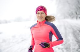 Woman out for a run in the winter snow to keep fit