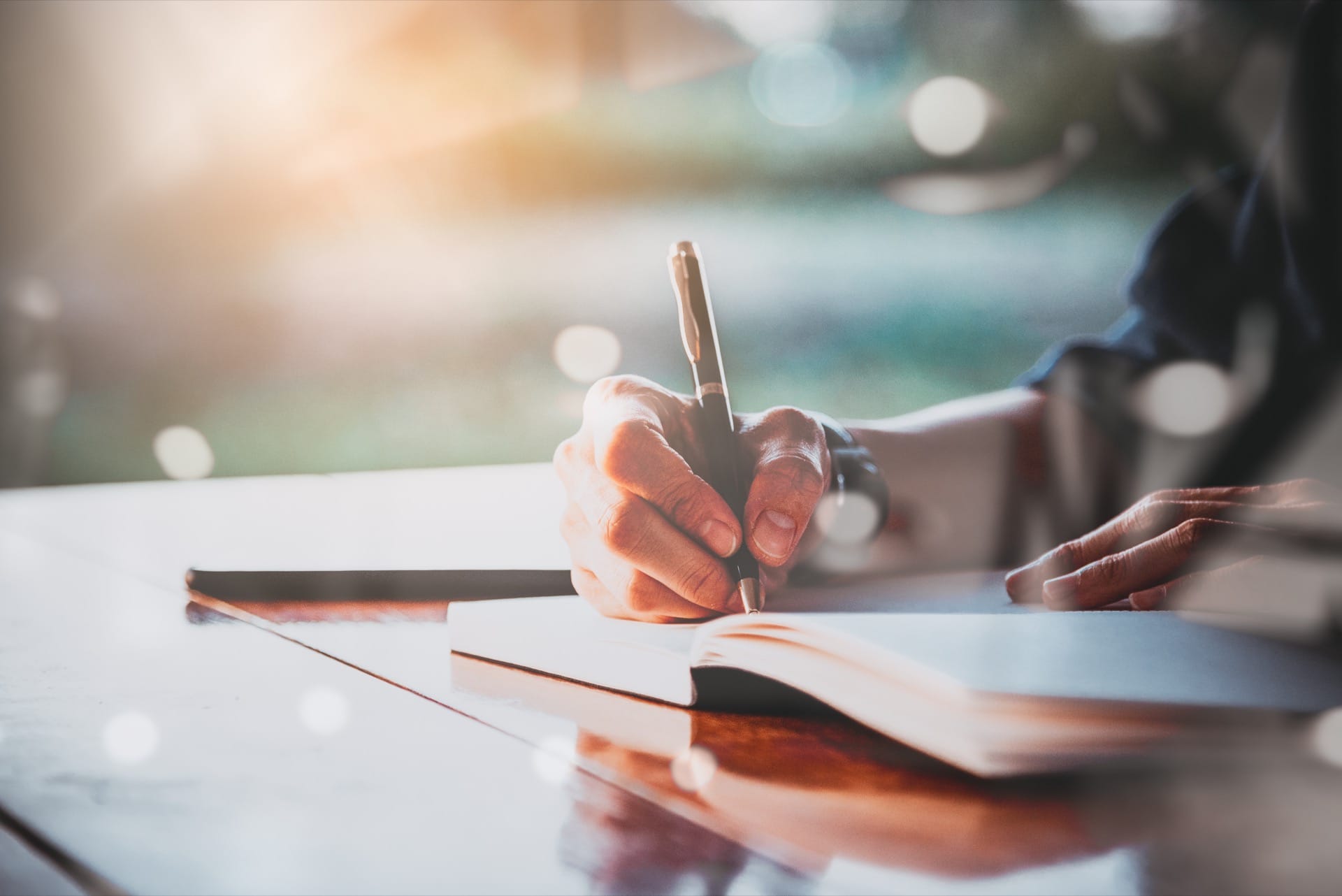 Person writing in a book - Your Health