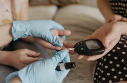 Pricking finger on blood glucose meter